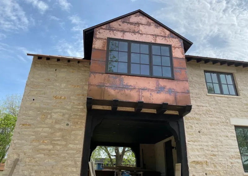 Copper metal panel facade on a stone building for Metal Roof Coating in Ridgeway